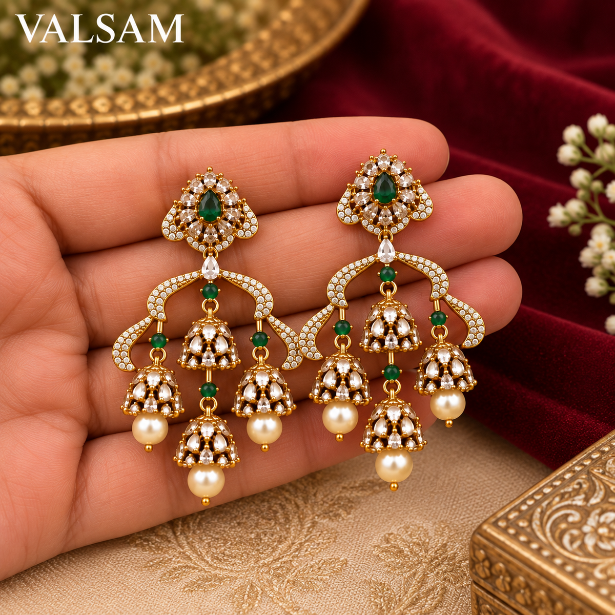 VALSAM green stone chandelier jhumka earrings held in hand