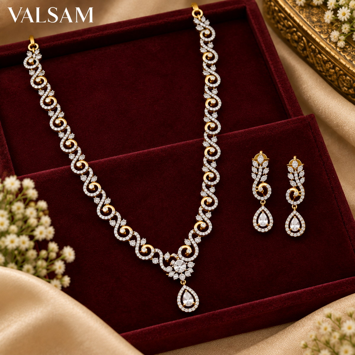 Gold plated crystal necklace set with matching earrings displayed on burgundy velvet