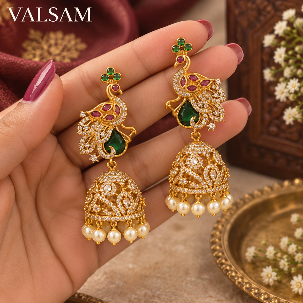 VALSAM peacock jhumka earrings held in hand showing detailed design